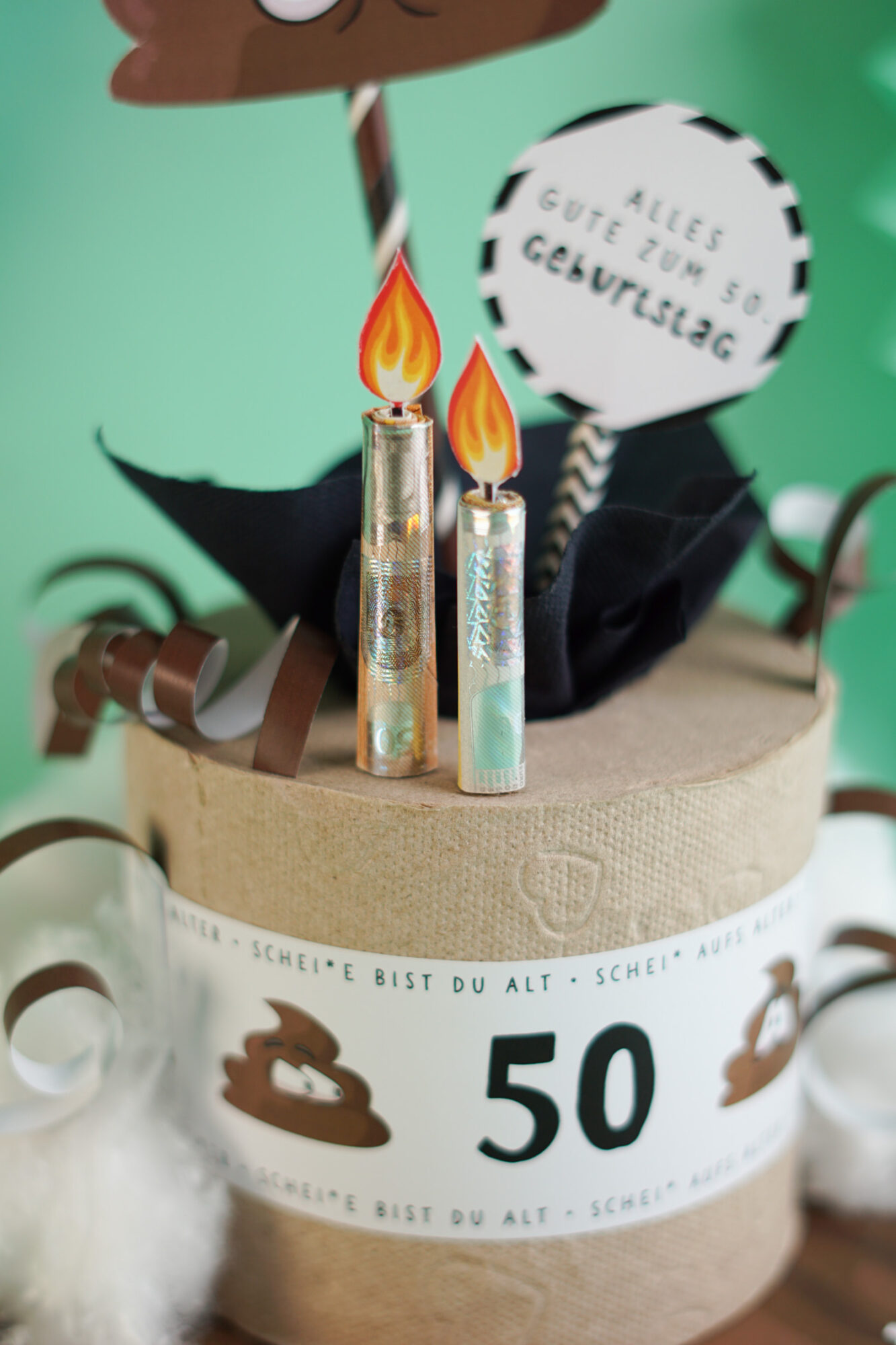 Lustiges Geburtstagsgeschenk Klorolle als Geburtstagstorte mit Aufschrift Schei aufs Alter und der Zahl 50, Geldscheine als Kerzen, Kackhaufen Topper mit Wackelaugen
